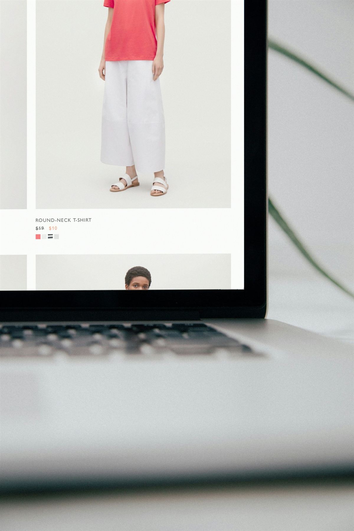 A laptop showing a product page in an online clothing shop